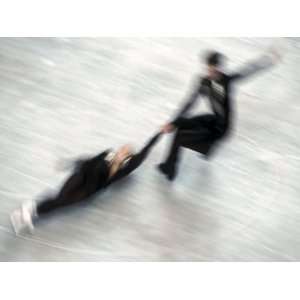 Blured Action of Pairs Figure Skaters Doing a Death Spiral 