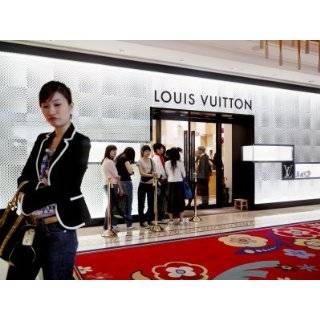 Shoppers Await Entry into the Louis Vuitton Boutique at a Hotel 