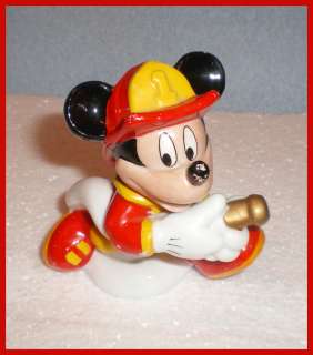 This vintage figurine of Mickey Mouse Fireman stands four inches high 