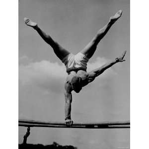  Krotzsch Doing a One Armed Hand Stand on the Bar Stretched 