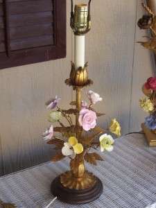 with gold gilt leaves and stems starting from a round wood base 