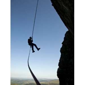 Climber Abseiling from a Cliff in the Ogwen Valley, Snowdonia, North 