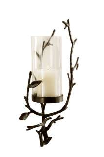   candle holder mounts to the wall and includes the tall glass hurricane